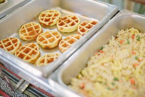 A buffet with waffles and fried rice. - The Odyssey Serviced Apartment (Chiang Mai)