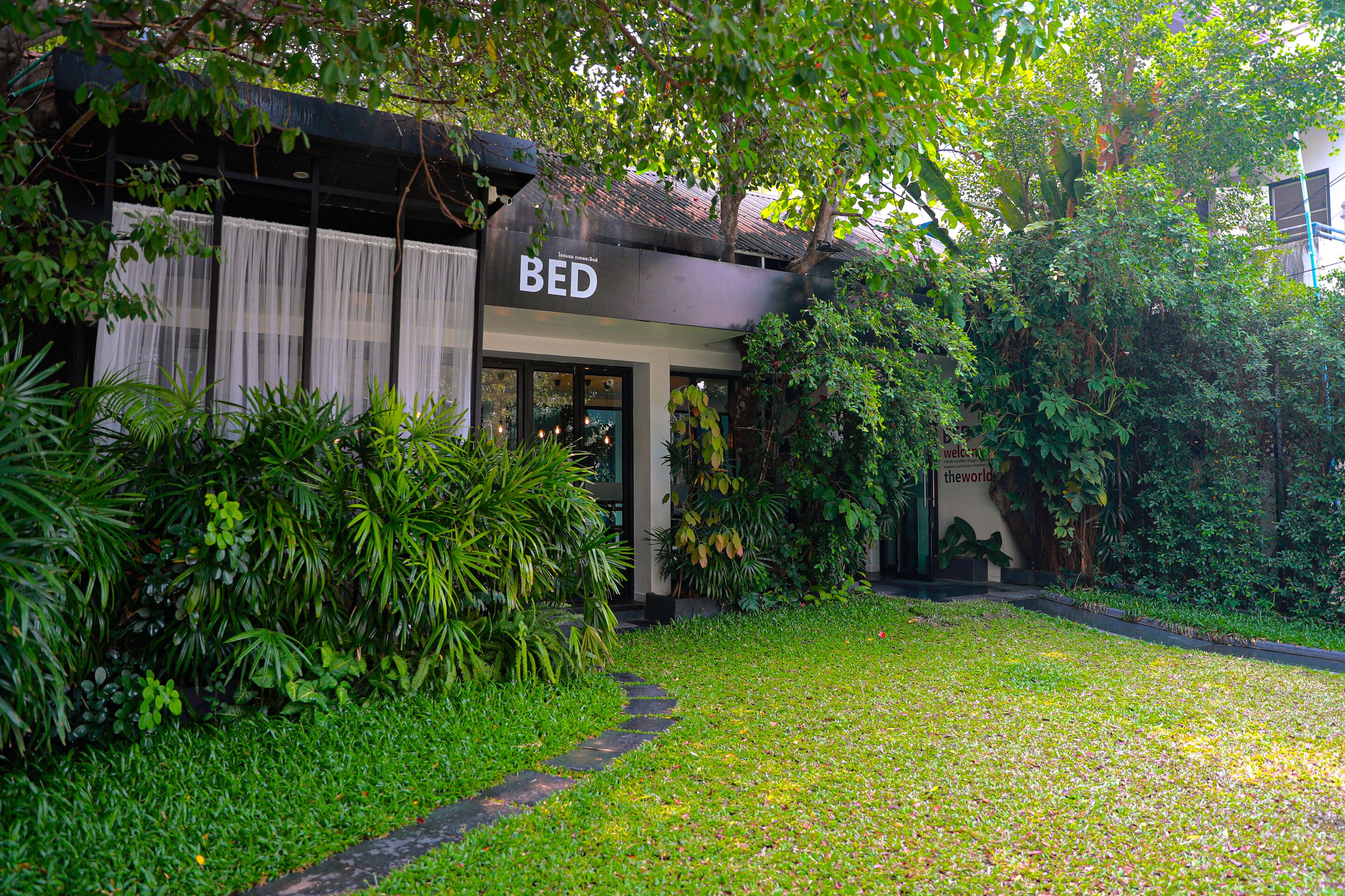 A building with a sign reading "BED" and a pathway leading to it.