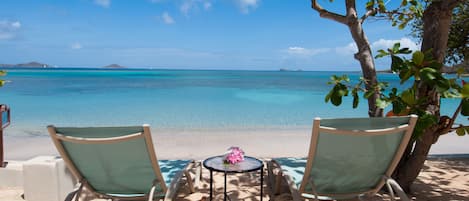 On the beach, white sand, sun loungers, beach umbrellas