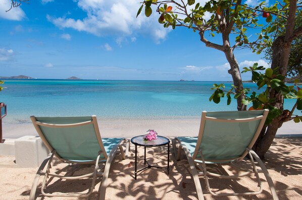 On the beach, white sand, sun-loungers, beach umbrellas