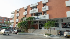Un hotel con fachada de ladrillo rojo, balcones y un letrero que dice "Barahona 72".