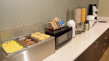 A buffet area with various food options and a coffee station.