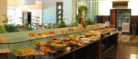 A buffet with various food items and a glass display case.