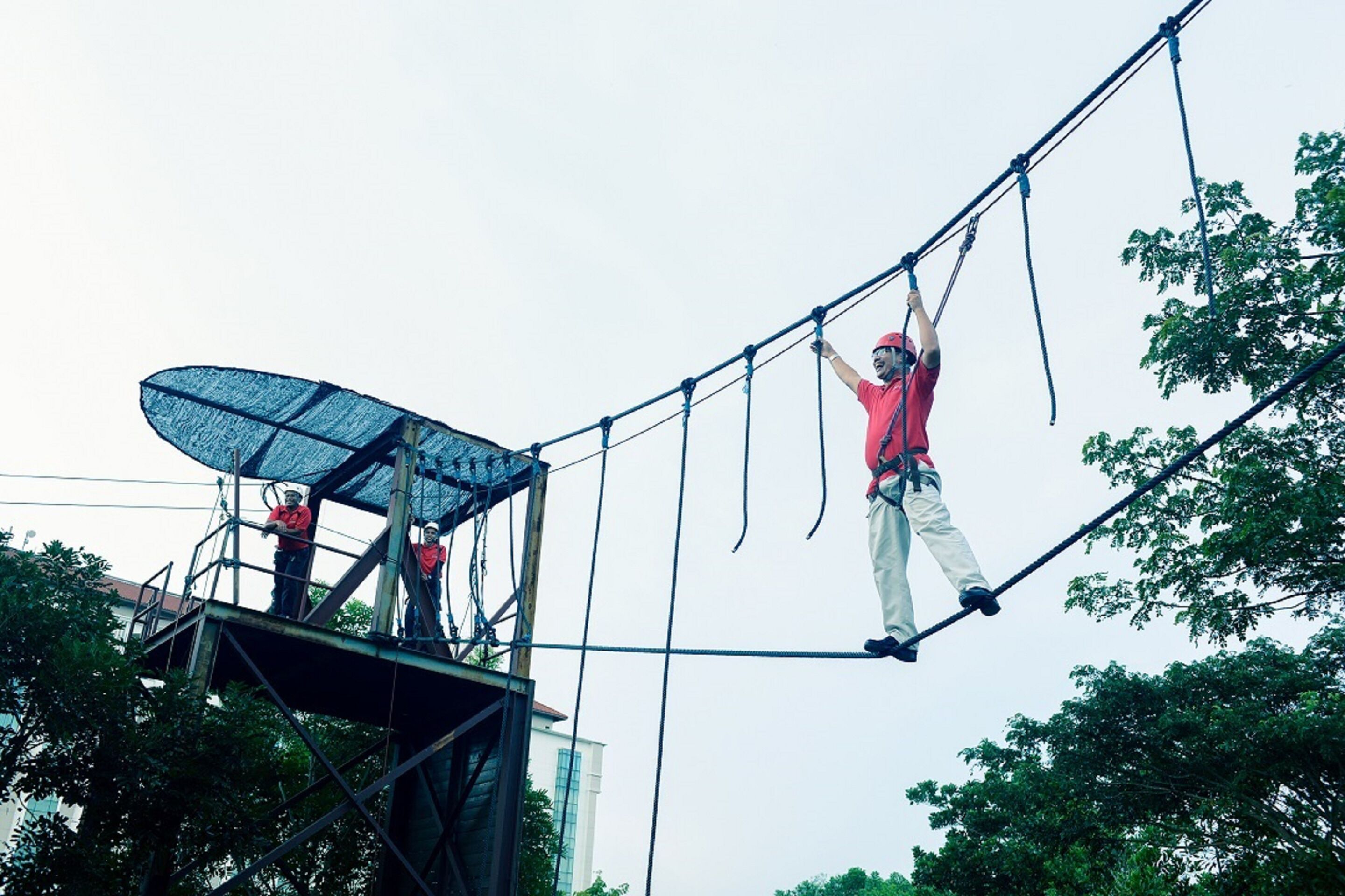 A person performing an aerial act on a trapeze.
