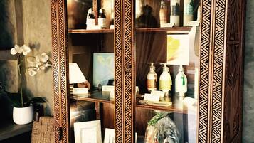 A wooden cabinet with intricate carvings and glass doors displaying various items.