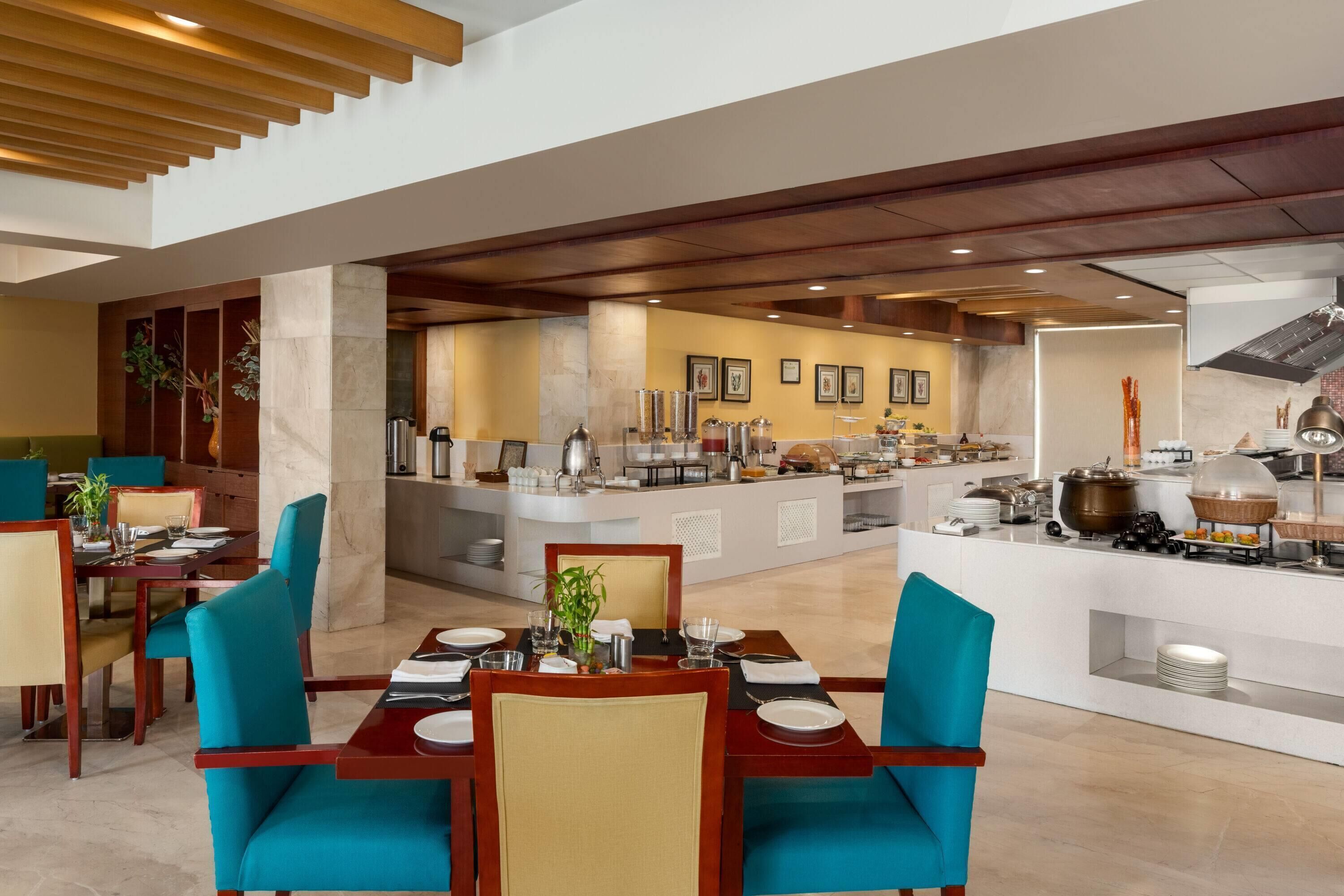 A spacious dining area with high ceilings and a central island with a buffet.