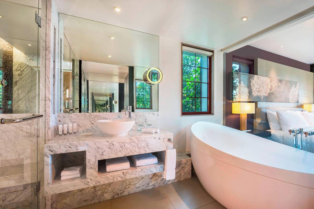 suite, 1 king bed, non smoking, balcony | bathroom | separate bathtub and shower, rainfall showerhead, free toiletries