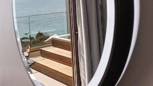 A window with a view of a body of water and a distant landmass. - Enjoy Lichnos Bay Village, Camping, Hotel & Apartments (Parga)
