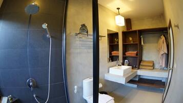 Un baño moderno con ducha, inodoro y tocador.