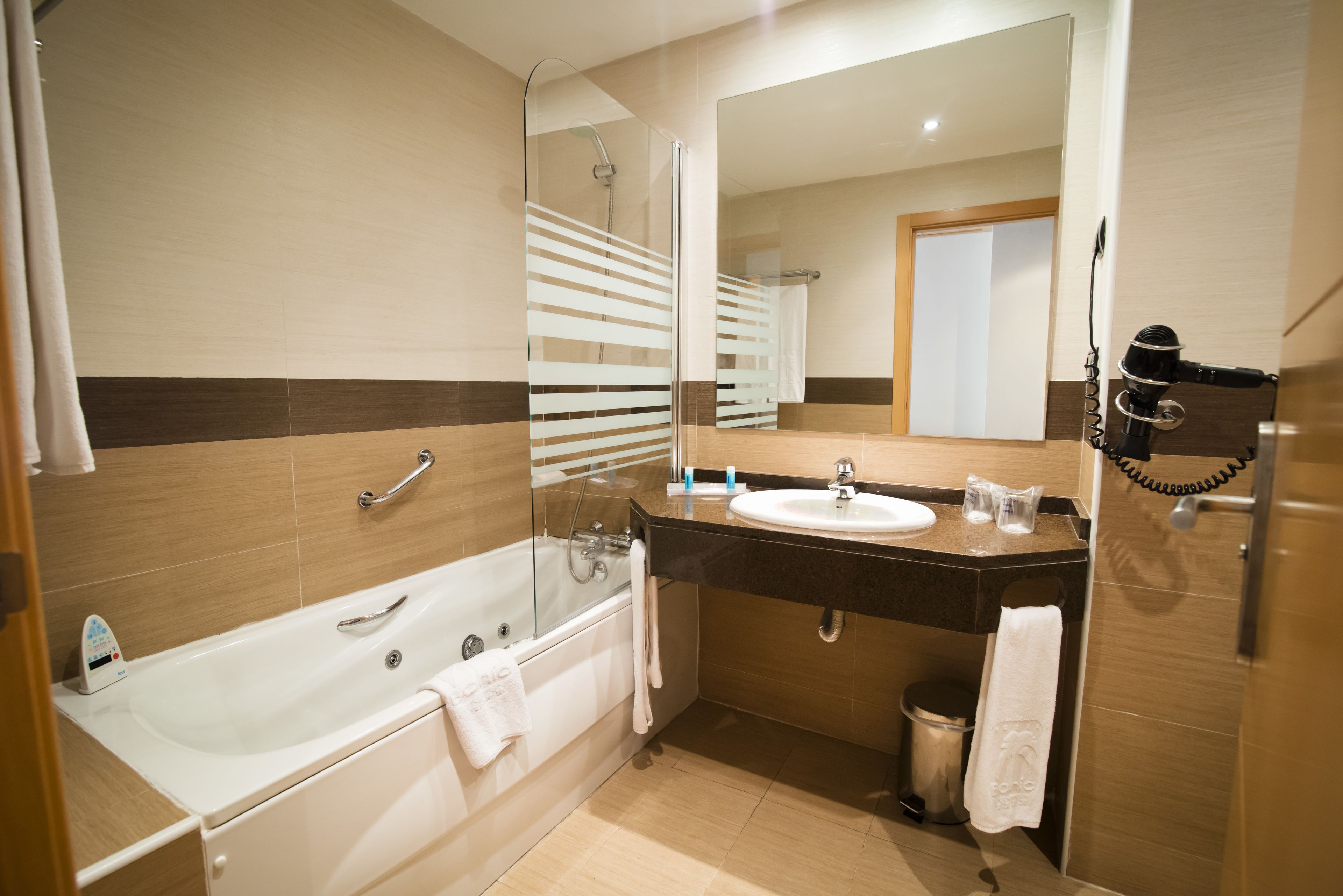 bathtub, free toiletries, hair dryer, towels