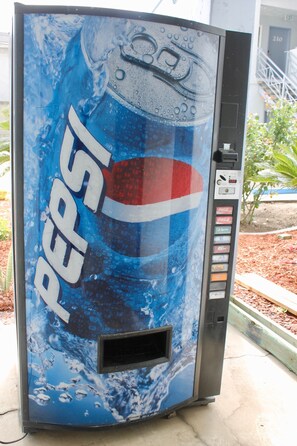A Pepsi vending machine with a large Pepsi logo and a water splash design. - Crescent Inn (Wilmington)