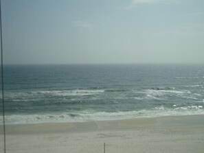 A beach with waves and a clear sky. - Tern Key Realty & Rentals (Pensacola)