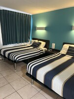 Premium bedding, desk, laptop workspace, blackout drapes