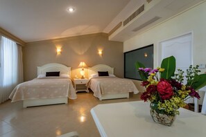 Two single beds with matching headboards and nightstands, each with a lamp, are featured in this inviting room.