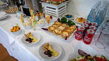 A buffet table with various food items and beverages.