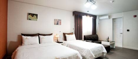 A hotel room with two beds, a desk, a chair, a lamp, and a painting on the wall.