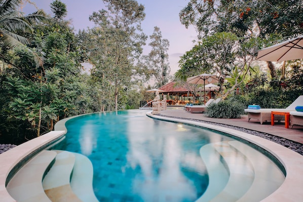 2 outdoor pools, a natural pool, open 7 AM to 9:00 PM, pool umbrellas