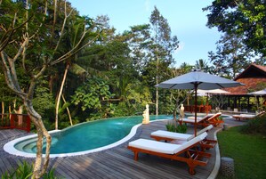 2 outdoor pools, a natural pool, open 7 AM to 9:00 PM, pool umbrellas