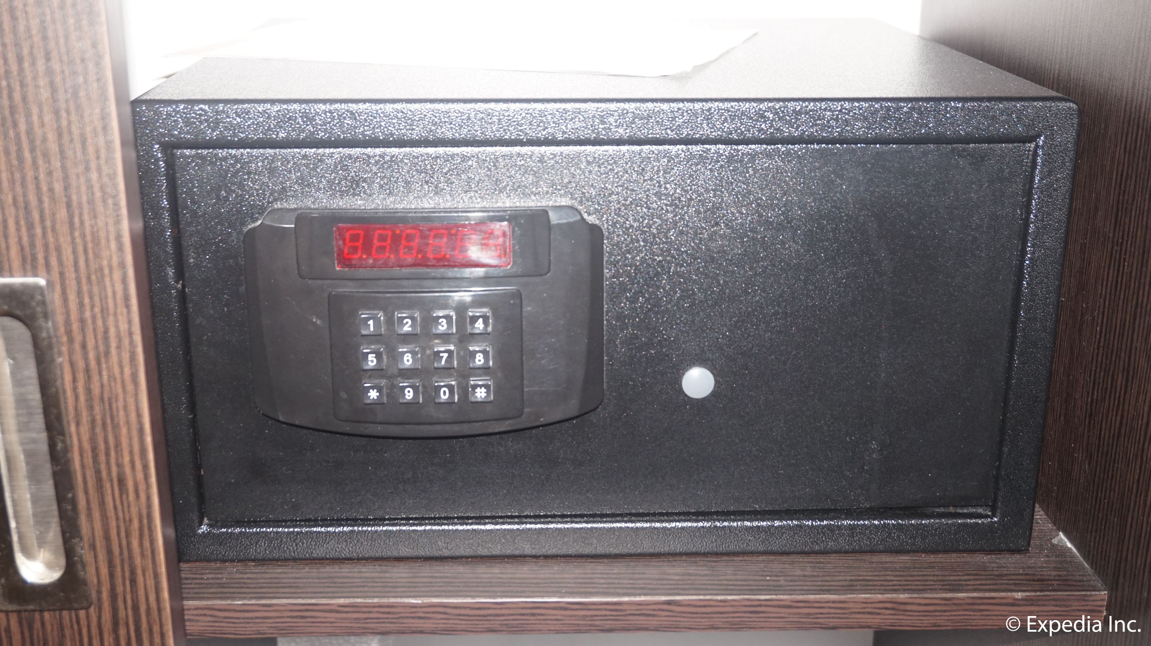 A black safe with a digital keypad and a red display.