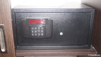 A black safe with a digital keypad and a red display.