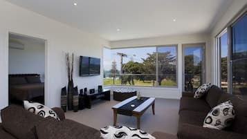 Premium 2 Bedroom Apartment #7B | Living room | Flat-screen TV