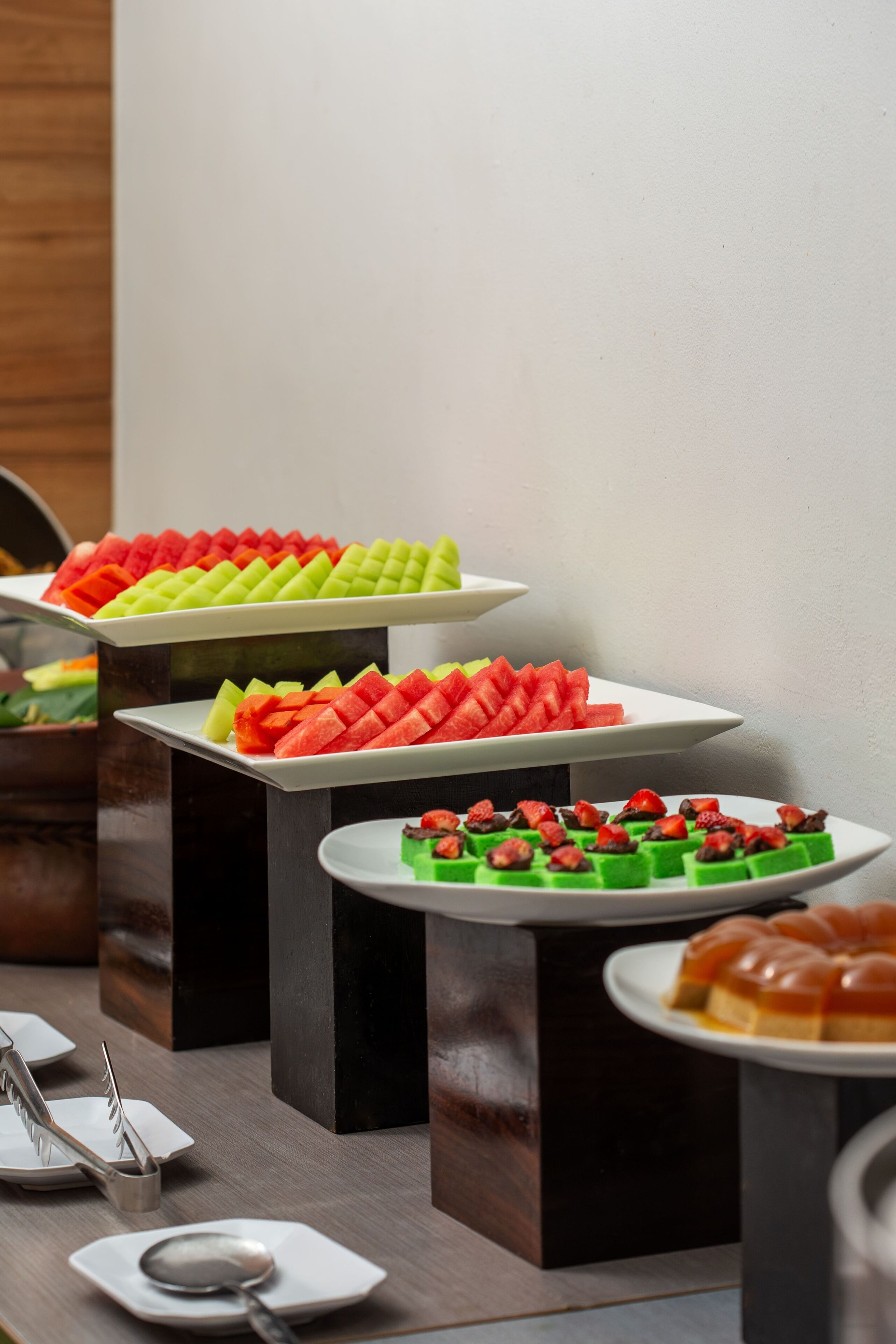 A buffet with various fruits and desserts.