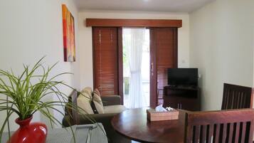 Room, 2 Bedrooms | Living area | 32-inch TV with satellite channels, pay movies