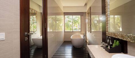 A modern bathroom with a bathtub, a large mirror, and a sink.