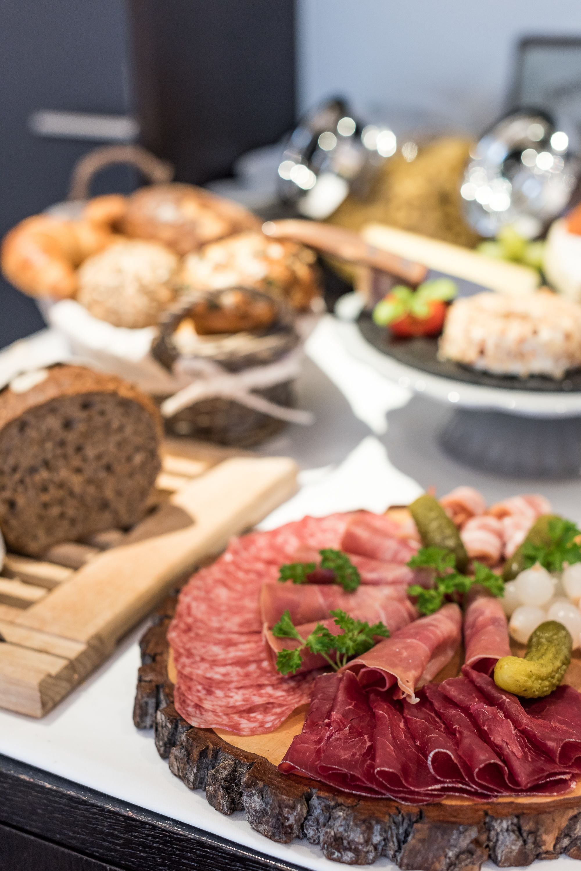 A charcuterie board with various meats and bread.