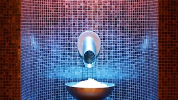 Bathroom features a unique, textured tile design and a round sink with a pedestal base.