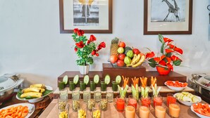 A buffet table with various fruits, vegetables, and beverages. - Ginger Vadodara,Alkapuri (Vadodara)