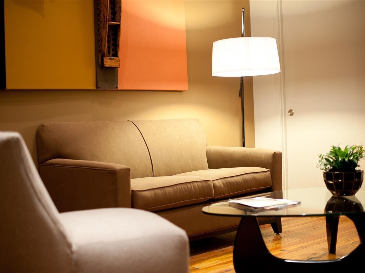 A modern living room with a sofa, a coffee table, and a floor lamp.