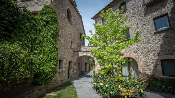 A stone building with an arched passageway and a sign reading "Renaissance Entry". - L'Arcada de Fares (Sant Ferriol)