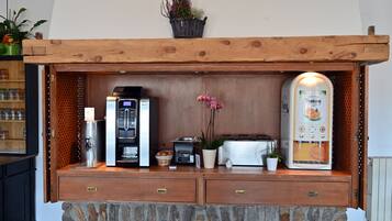 A kitchenette with a coffee maker, toaster, and a water dispenser.