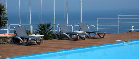 Seasonal outdoor pool, pool umbrellas, pool loungers