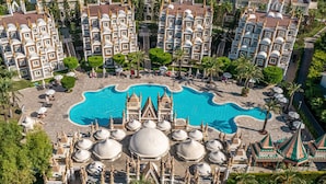 A large hotel complex with multiple buildings, a central swimming pool, and surrounding palm trees. - Kamelya Selin Hotel Luxury Resort & SPA (Manavgat)