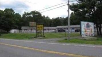 A road with a yellow sign and a billboard.