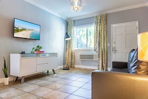 One Bedroom Double Queen Suite | Living area | 42-inch flat-screen TV with cable channels, TV, iPod dock