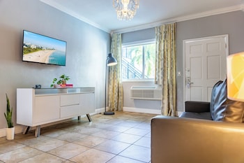 One Bedroom Double Queen Suite | Living area | 42-inch flat-screen TV with cable channels, TV, iPod dock at Beachside All Suites Hotel