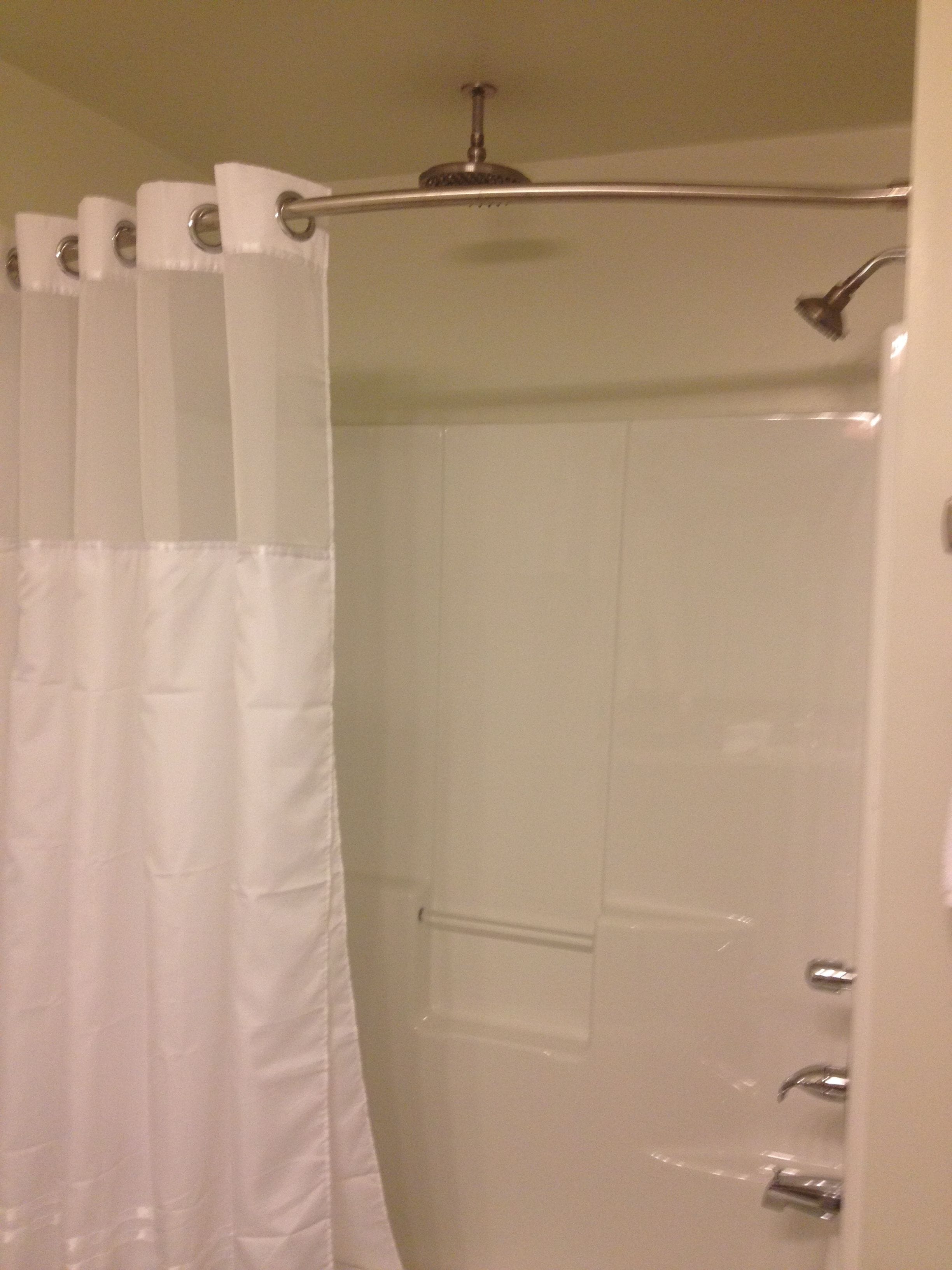 A bathroom with a shower, a toilet, and a bathtub.