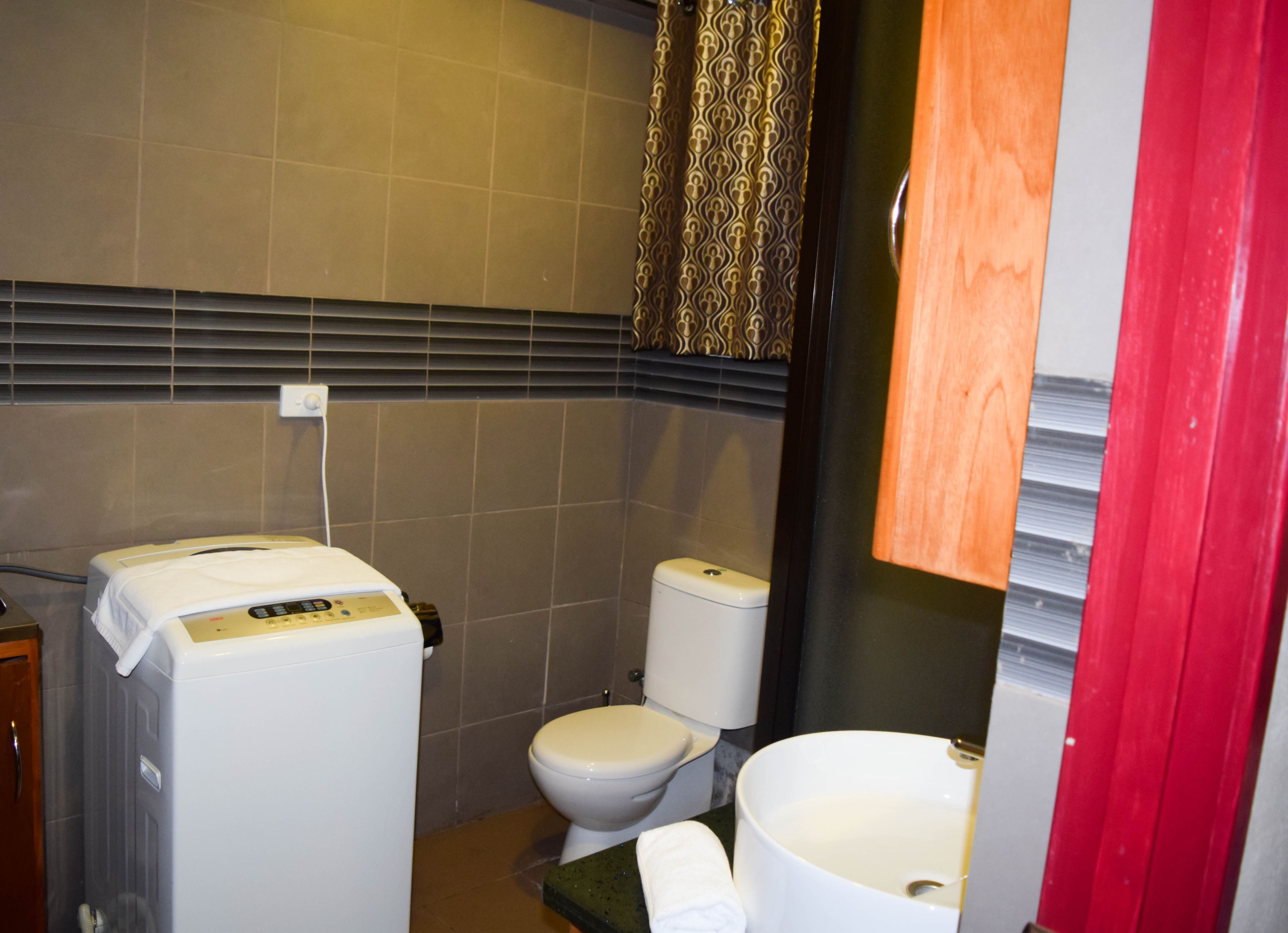 A bathroom with a toilet, a bidet, and a sink.