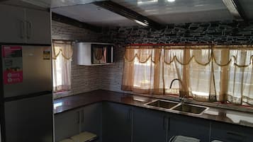 Three Bedroom Apartment | Private kitchen | Fridge, microwave, stovetop, electric kettle