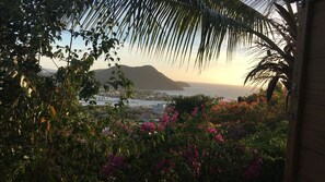 A coastal view with a marina, buildings, and mountains in the background. - Italian Guesthouse (Gros Islet)