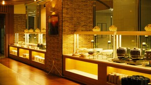 A hotel reception area with a brick wall, a glass display case with various items, and a wooden counter. - Mona Yongpyong Villa Condominium (Pyeongchang)