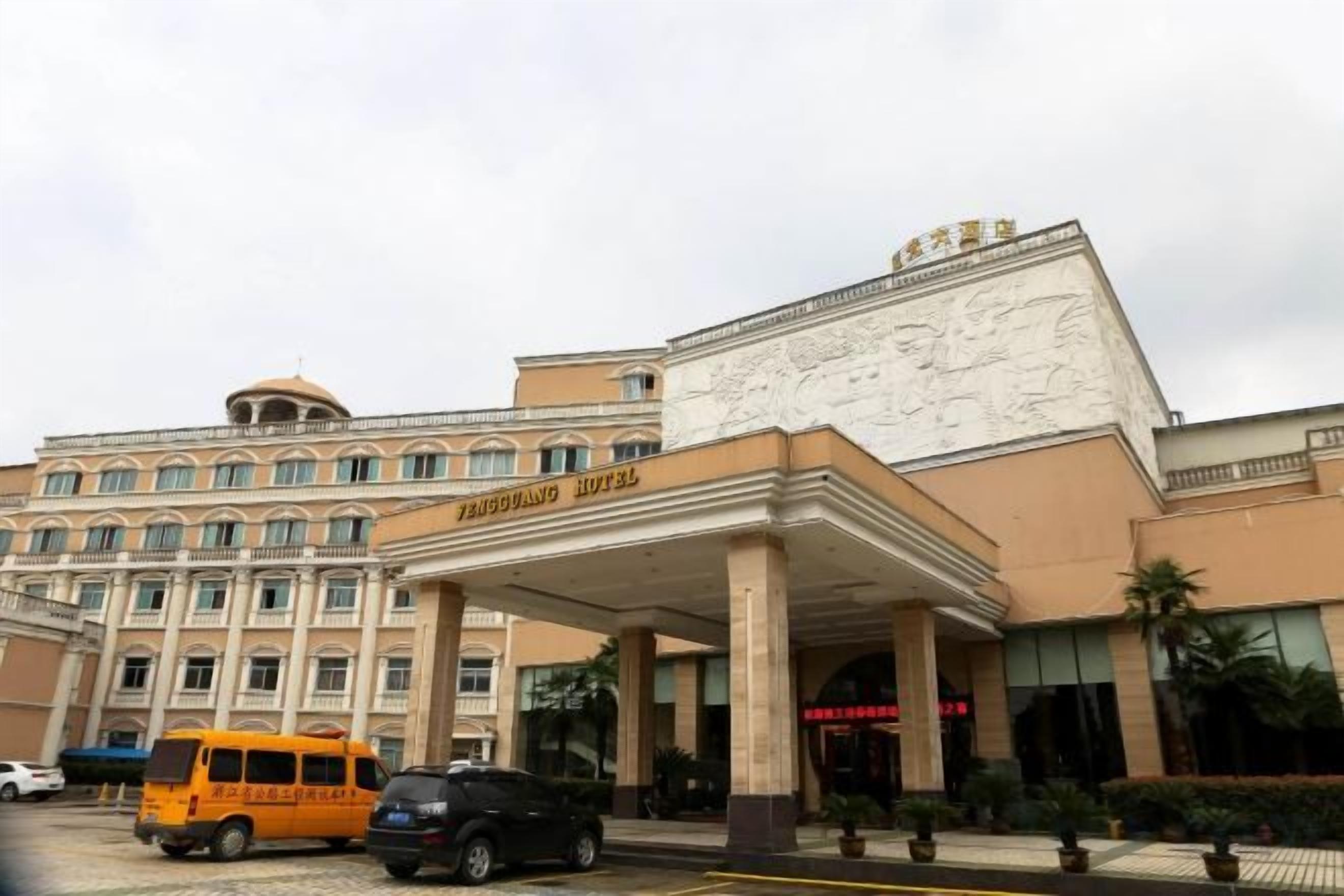 A hotel with a prominent entrance, a covered area, and a large building facade.