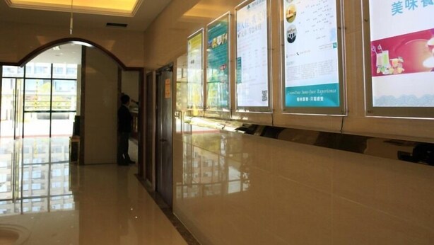 A corridor with a polished floor, glass doors, and informational posters on the walls. - GreenTree Inn Zhoushan Putuo Donggang Hotel (Zhoushan)