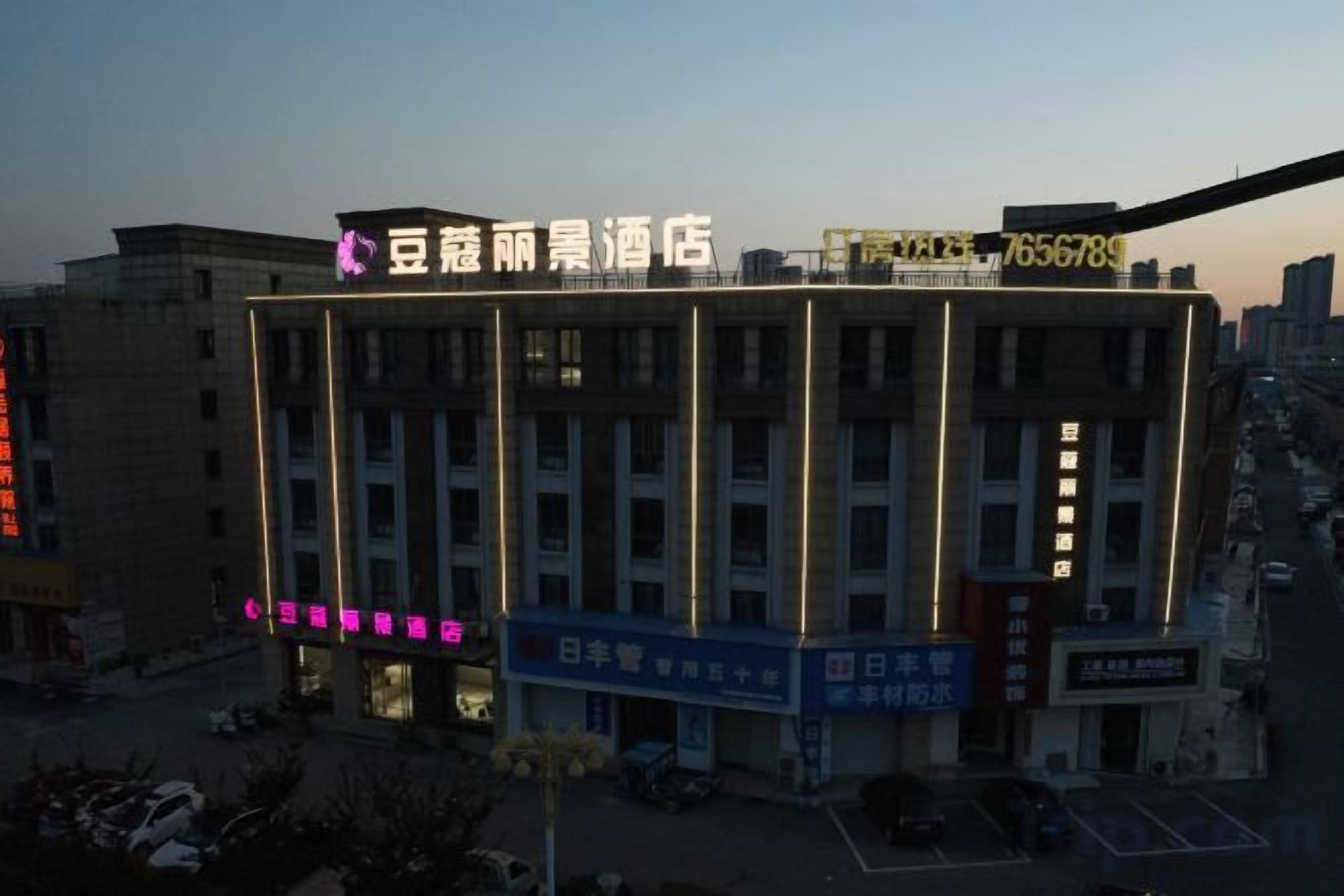 A multi-story hotel with a prominent sign at the top.