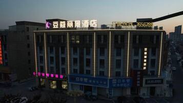 A multi-story hotel with a prominent sign at the top.