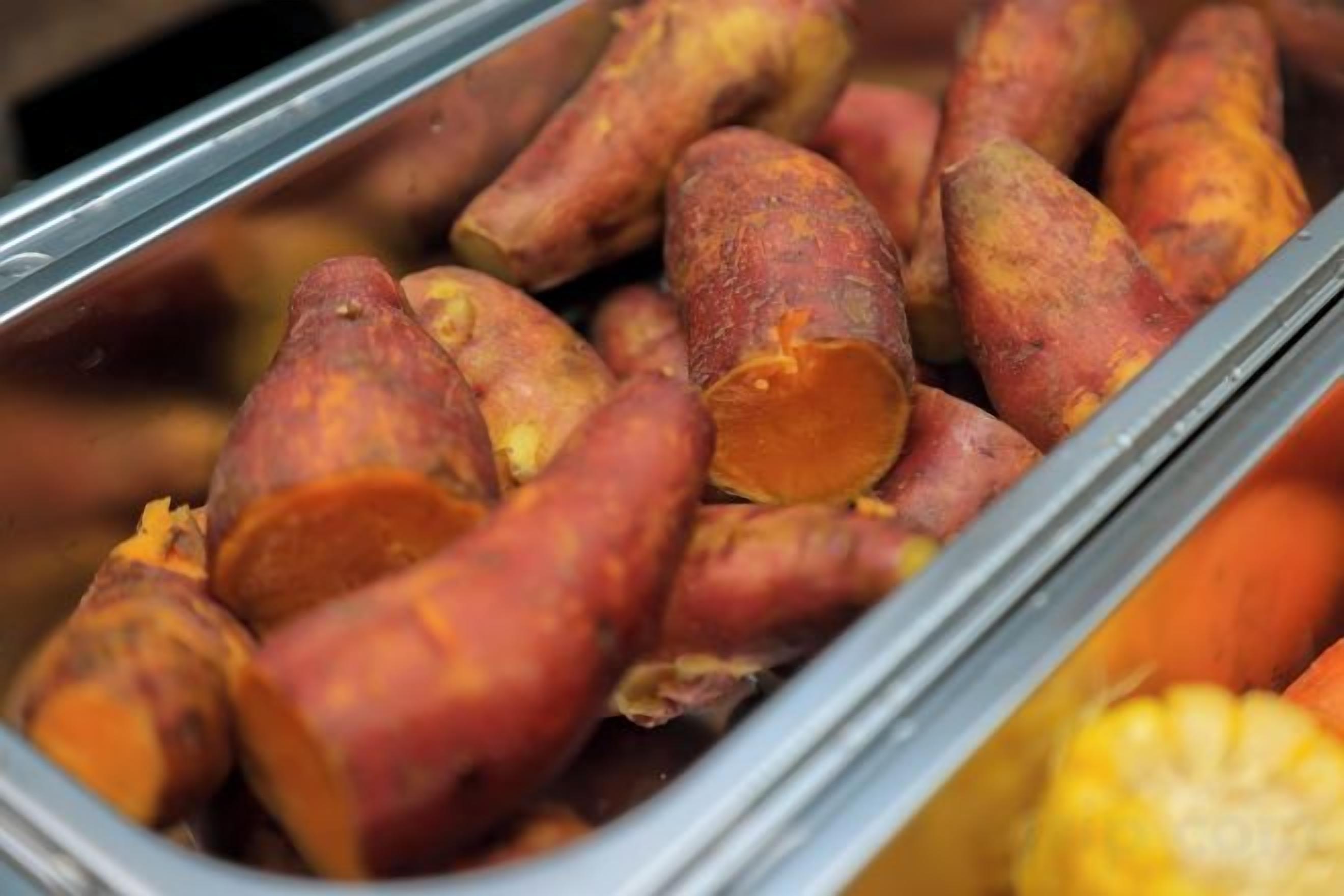 A container filled with sweet potatoes.