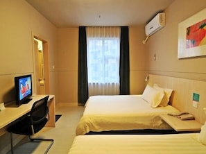 A hotel room with two beds, a desk with a television, and a window with curtains. - Jinjiang Inn Xiamen Hexiang Road West (Xiamen)